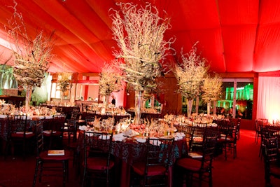Dark tables and chairs brought attention to vibrant colors on tabletops boasting sprawling centerpieces that appeared to be plants frozen in motion contorting their way to the ceiling.