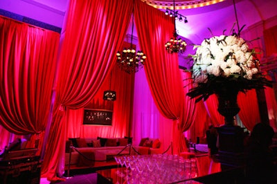 Floor-to-ceiling red curtains and oversize floral arrangements added to the dramatic ambience at the House of XX3.