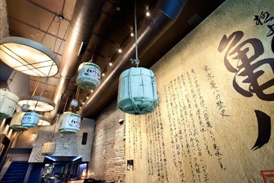 Calligraphy and hanging sake barrels spruce up the entryway.