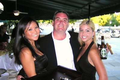 Guests with cigar girls at a university fund-raiser.