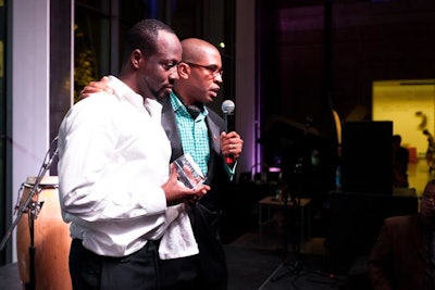Wyclef Jean joined gala chair and Askyon board member Reggie Canal onstage during the live auction.