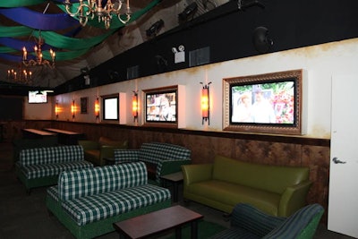 The main lounge, dubbed the 'Par-Tee' lounge, is styled after a country club and features plush couches, chandeliers, and TVs enclosed in ornate frames.