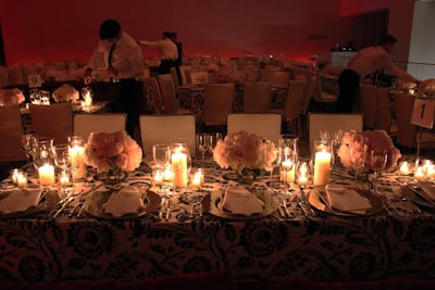 Contrasting the red velvet banquette-style couches, the chairs were decorated in white covers with black piping, a look that matched the black-and-white-patterned linens that draped each table.