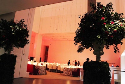Following the presentation in the Titus Theater that honored Almodóvar's career, guests headed up to the Donald B. and Catherine C. Marron Atrium on the second floor. The entrance to the space was flanked by large floral arrangements in urns placed atop column-shaped hedges.
