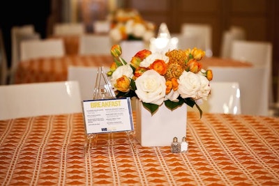 With the setting in the grand ballroom largely unchanged, the organizers looked to switch up the different breakout sessions with unique color schemes and centerpieces. For instance, the design of Monday's breakfast in the Terrace Room employed orange and white hues that extended from the tablecloths and arrangements to the sofas and throw pillows. Additionally, the organizers set up only a handful of traditional round tables, encouraging attendees to network by spreading highboys without chairs throughout the space.