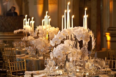 To match the neutral color scheme used in the ballroom for the majority of the sessions, the production team topped each table with architectural arrangements of white orchids, transparent candelabra, and teal tablecloths with gold floral appliques.