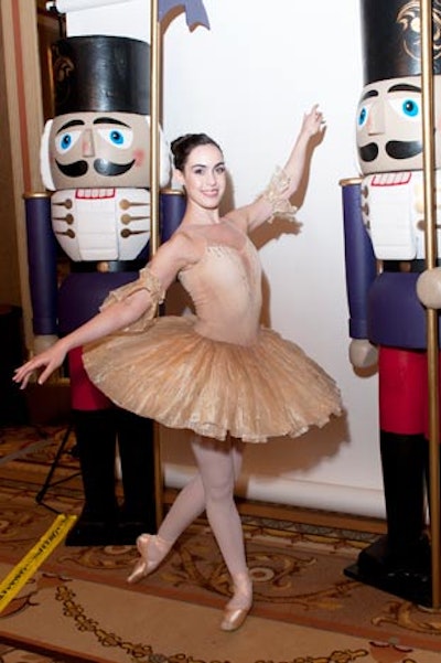 Wes Cleaver Photography set up a station that let guests—and ballerinas—pose for keepsake photos between nutcracker statues. The parting gift was a brushed-steel frame with the event's logo from CFX Marketing.