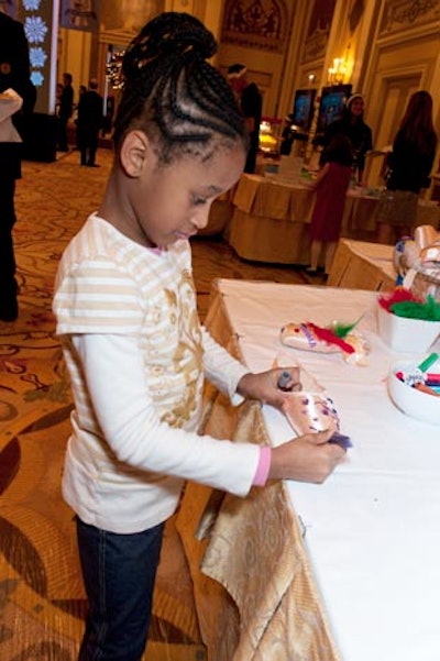 Kids used markers, feathers, and stick-on jewels to decorate the silky slippers.