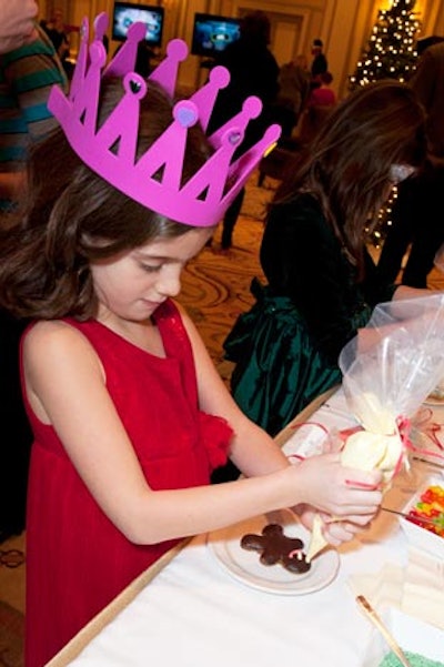 Another station let guests decorate gingerbread men and cupcakes with colored frosting, candy canes, and M&Ms.