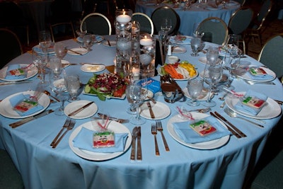 In the ballroom, plates were set with nutcracker-shaped cookies. Ivan Carlson's decor included sliver ornaments floating in cylindrical vases.