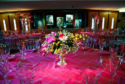 JLB Floral created different centerpieces for each table using orchids, roses, lilies, and greenery adorned with crystals in vases of various sizes and heights.