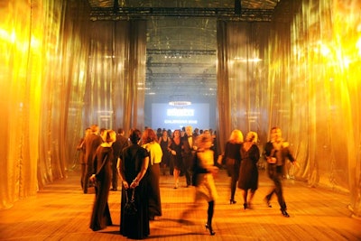 Gray-hued sheer curtains 32 feet long formed a breezeway through which guests entered the Drill Hall for dinner. The drapes also doubled as a shield to keep the after-party section closed off until the end of the performance.