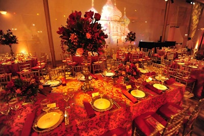 Floral arrangements, fabrics, and light projections all incorporated rich shades of gold and red.