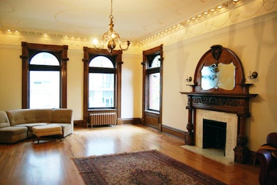 The drawing room can accommodate up to 50 seated and has large windows and a working fireplace. The ceiling is lined with delicate lights, and a bird motif borders the crown moulding.