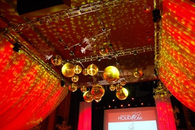 A lighting display built with gold mirror balls and over-size snowflakes hung over the dance floor. The mirror balls sent gold reflections across the dining room.
