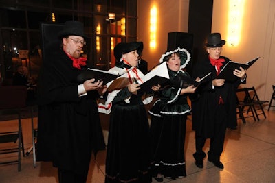 Carolers dressed in festive Christmas attire greeted guests.