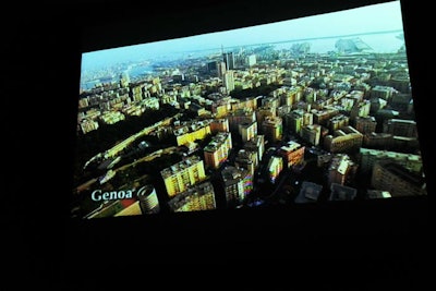 Travel videos of different towns in Italy played on the big screen in the auditorium adjacent to the atrium.