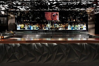 The bar remains at the venue, and a new screen embedded into the backdrop plays video.