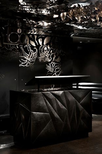 The sculpted look of the DJ booth matches the design of the venue and comes fully equipped with gear.