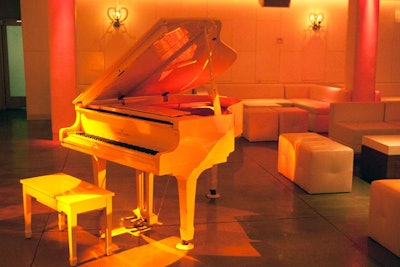 A white baby grand piano lends a luxe look.