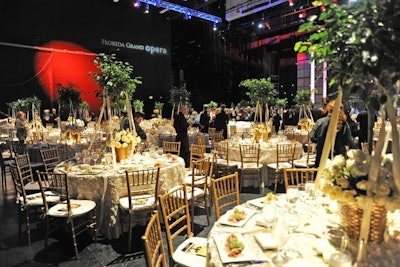 Topiary centerpieces stood on top of linens and tables provided by Panache.
