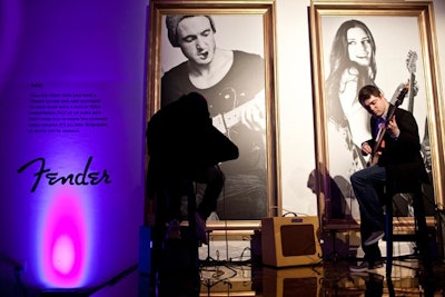 A gold-colored platform with a backdrop of black-and-white photos of musicians in gold frames held Fender Stratocasters, amplifiers, and headphones for the Picks section. Organizers invited attendees to try out the guitars.