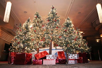 Faux Christmas trees and wrapped presents added to the festive decor in the reception space.