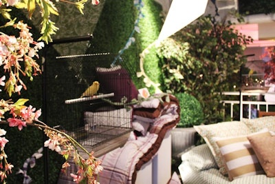 Inside Openhouse Gallery's garden-like setting, Sears brought in more foliage, benches, and six live canaries to complement the colorful wares of its 2012 spring collection. The half-dozen bright, yellow birds chirped from freestanding cages placed around the product vignettes.