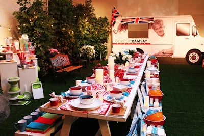 An over-size picnic table continued the warm-weather motif and provided a creative setting for the brand to showcase the brightly colored tableware in the Sandra by Sandra Lee collection.