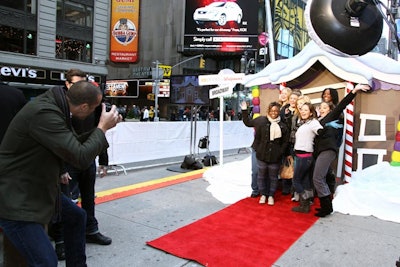 Consumers lined up in front of a gingerbread house setup where Barker posed them before shooting.