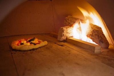 A brick oven cooks 10-inch pizzas in flavors such as eggs and bacon, cream cheese and lox, and fennel sausage.