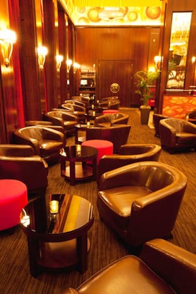 The lounge area, separated from the main dining room with hand-painted half walls, has red mohair ottomans, leather club chairs, and low glass tables.