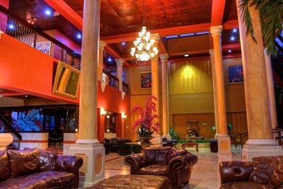 The Regency Hotel Miami's grand lobby has different seating niches and a rich, colorful palette.