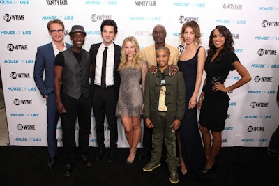 The show's stars posed in front of the step-and-repeat wall.