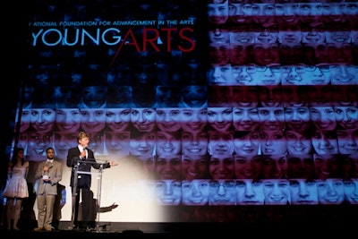 Lin Arison presented actor, director, and activist Robert Redford with the Arison Award. Embedded with the faces of teenagers, a digital image of an American flag decorated the stage at the ceremony.