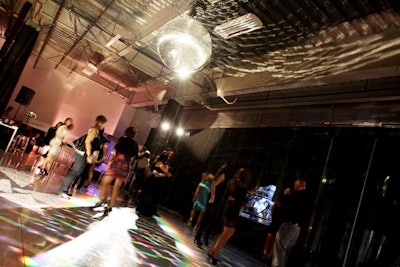 The disco ball cast glittering lights onto the dance floor.