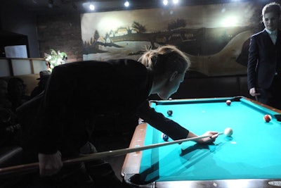 As each area was set up to tell a different story in the collection, the games room also included models socializing and playing billiards, or 'snooker,' as the Brits say, to show the clothes in an interactive environment.
