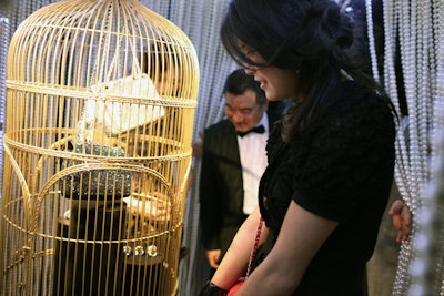 Stepping through the beaded curtain, guests could view rare and special Chanel accessories and jewelry displayed inside gilded bird cages.