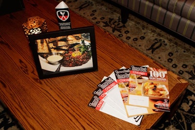 Issues of the magazine were fanned out on tabletops, along with signage that explained the Foursquare partnership and photos of the dishes mentioned in the '100 Best' feature.