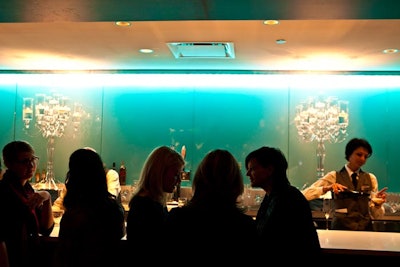 HMR Design Group placed Lucite candelabras on a bar outside the ballroom.