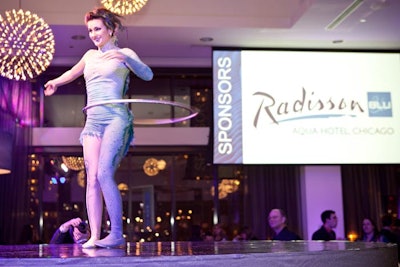 The performers did their tricks on circular stages throughout the ballroom, where drop-down screens showcased sponsor logos.