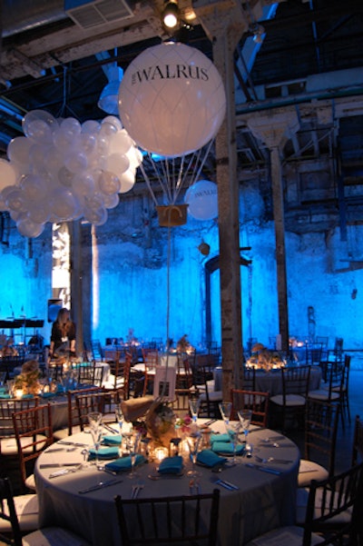 Beneath the floating decor, Chair-Man Mills provided Bormioli glasses and colourful blue napkins that brightened the tables. As a small gift, wine stoppers topped with a glass globe awaited guests at their place settings.