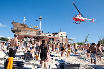 A helicopter flew out to capture video of a beach party held on a private island in the Bahamas for Holy Ship! guests with Fatboy Slim.