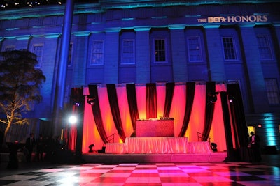 A sparkly purple DJ booth flanked the black-and-white tiled dance floor in the middle of the courtyard.