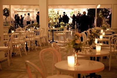 White banquettes, chairs, and marble-topped tables gave the café a more authentic look. For a whimsical touch, Target inserted the night's menu in white photo frames and placed them on the tables.