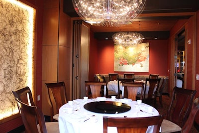 Genting Palace's private room has soft, suspended lighting above dining tables.