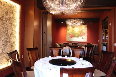 Genting Palace's private room has soft, suspended lighting above dining tables.