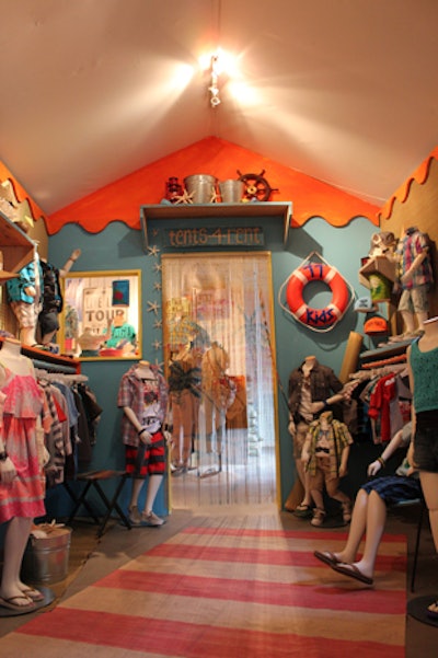 Under a thatched roof cabana decorated with sand, seashells, and straw beach mats repurposed as wallpaper, American Eagle showcased new clothing and accessories from its children's line 77Kids.
