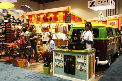 Yaga clothing company used bright colors, tropical plants, a makeshift bar, and reggae music to create a booth that reflected the Jamaican vibe of its products.
