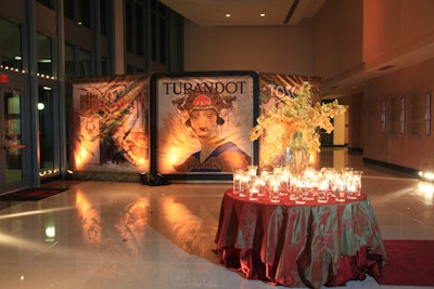 Artwork with characters and scenes from various operas stood in the lit hallway leading to the Cohen Pavilion's ballroom.